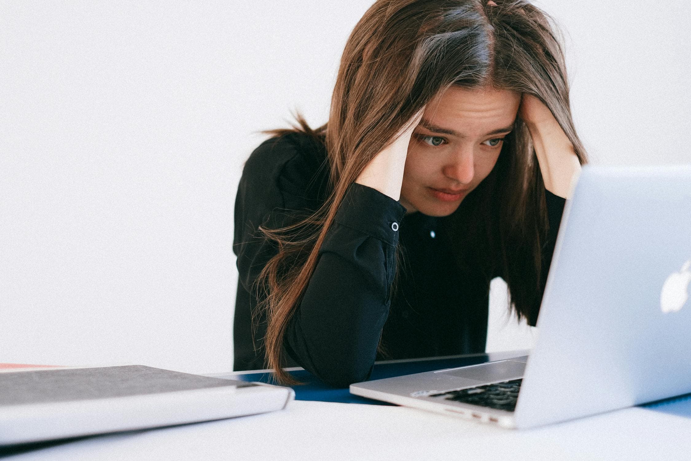 A frustrated parent looking at a laptop screen during camp registration